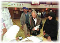An election official checks voter registrations in Dearborn, Michigan, November 7, 2000.