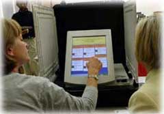 A county official in Georgia operates a new touch-screen voting machine in October, 2002.